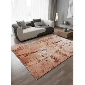Photo of 8' Orange Brown And White Abstract Washable Round Rug With UV Protection