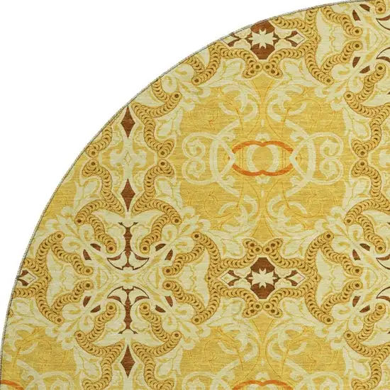 8' Orange Gold And Ivory Medallion Washable Round Rug With UV Protection Photo 3