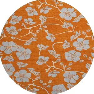 Photo of 8' Orange Gray And Ivory Floral Washable Round Rug With UV Protection