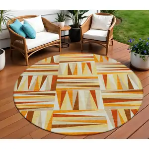 Photo of 8' Orange Ivory And Copper Round Geometric Washable Indoor Outdoor Area Rug