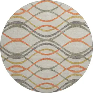 Photo of 8' Orange Ivory And Gold Abstract Washable Round Rug With UV Protection