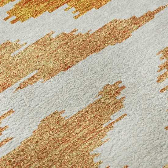 8' Orange Ivory And Gray Abstract Washable Round Rug With UV Protection Photo 9