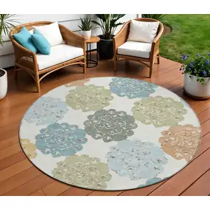 Photo of 8' Pacific Blue Ivory And Copper Round Quatrefoil Washable Indoor Outdoor Area Rug