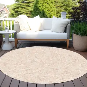 Photo of 8' Peach And Beige Round Geometric Washable Indoor Outdoor Area Rug
