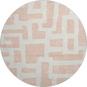 Photo of 8' Peach And Ivory Abstract Geometric Washable Round Rug With UV Protection