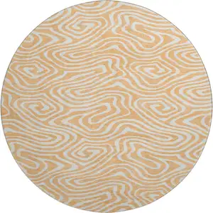 Photo of 8' Peach And Ivory Abstract Washable Round Rug With UV Protection