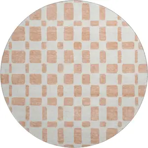 Photo of 8' Peach And Ivory Geometric Washable Round Rug With UV Protection
