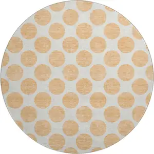 Photo of 8' Peach And Ivory Polka Dot Washable Round Rug With UV Protection
