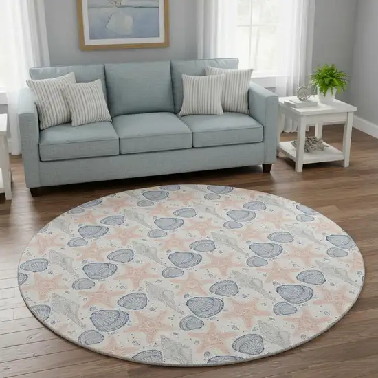 8' Peach Ivory And Navy Blue Geometric Washable Round Rug With UV Protection Photo 1