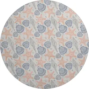 Photo of 8' Peach Ivory And Navy Blue Geometric Washable Round Rug With UV Protection