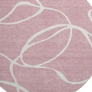 Photo of 8' Pink And Ivory Abstract Washable Round Rug With UV Protection