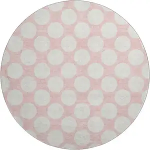Photo of 8' Pink And Ivory Polka Dot Washable Round Rug With UV Protection