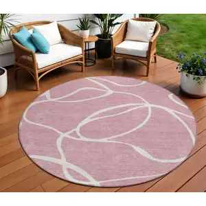 Photo of 8' Pink And Ivory Round Abstract Washable Indoor Outdoor Area Rug