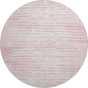 Photo of 8' Pink And Ivory Striped Washable Round Rug With UV Protection