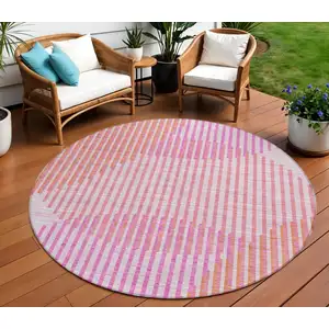 Photo of 8' Pink Copper And Ivory Round Geometric Washable Indoor Outdoor Area Rug
