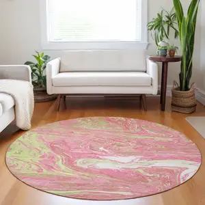 Photo of 8' Pink Green And Ivory Round Abstract Washable Indoor Outdoor Area Rug