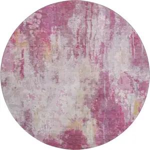 Photo of 8' Pink Peach And Ivory Abstract Washable Round Rug With UV Protection