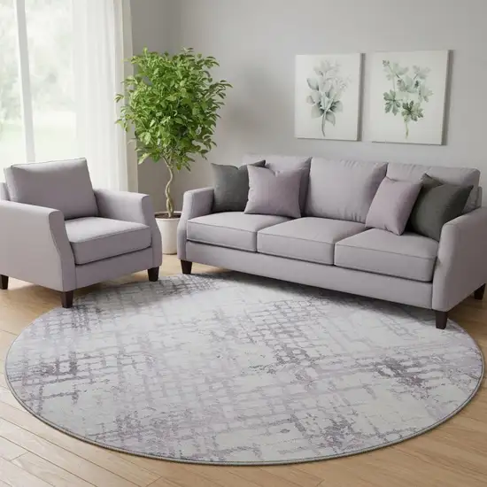 8' Purple And Ivory Abstract Geometric Washable Round Rug With UV Protection Photo 1