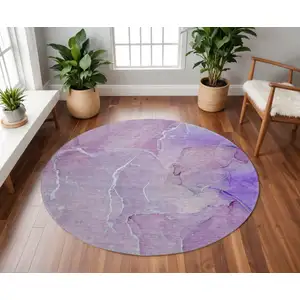 Photo of 8' Purple And Ivory Abstract Washable Round Rug With UV Protection