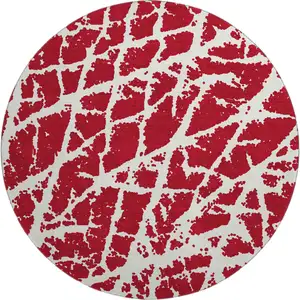 Photo of 8' Red And Ivory Abstract Washable Round Rug With UV Protection