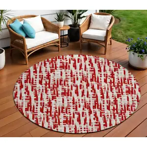 Photo of 8' Red And Ivory Round Abstract Washable Indoor Outdoor Area Rug