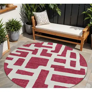Photo of 8' Red And Ivory Round Abstract Washable Indoor Outdoor Area Rug