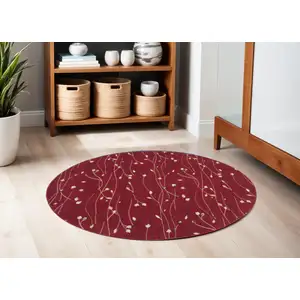 Photo of 5' Red Black and Ivory Round Floral Vines Power Loom Area Rug