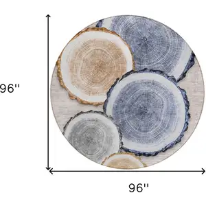 Photo of 8' Round Beige Blue and Gold Round Faux Bois Washable Non Skid Indoor Outdoor Area Rug