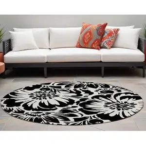 Photo of 8' Round Black and Ivory Round Floral Washable Non Skid Indoor Outdoor Area Rug