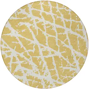 Photo of 8' Round Gold and White Round Abstract Washable Non Skid Indoor Outdoor Area Rug