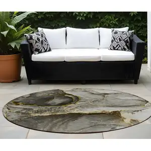 Photo of 8' Round Gray and Gold Round Abstract Washable Non Skid Indoor Outdoor Area Rug
