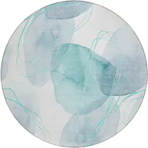 Photo of 8' Round Teal and Ivory Round Abstract Washable Non Skid Indoor Outdoor Area Rug