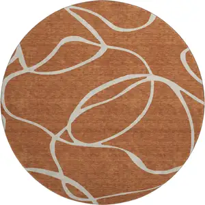 Photo of 8' Rust And Beige Abstract Washable Round Rug With UV Protection