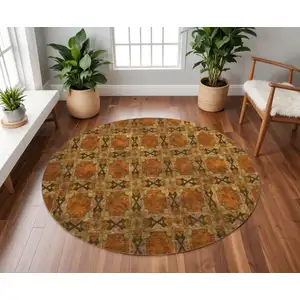 Photo of 8' Rust Copper And Gold Floral Medallion Washable Round Rug With UV Protection