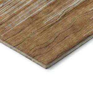 Photo of 8' Rust Ivory And Gold Striped Washable Round Rug With UV Protection