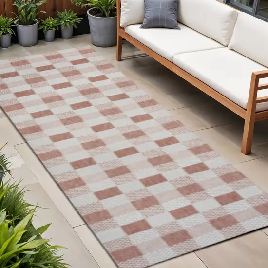 8' Salmon And Cream Geometric Indoor Outdoor Runner Rug Photo 1