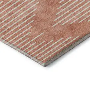 Photo of 8' Salmon And Ivory Geometric Washable Round Rug With UV Protection