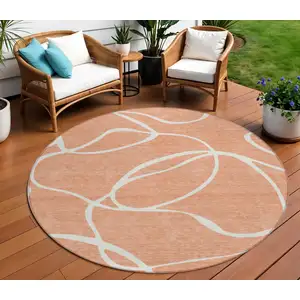 Photo of 8' Salmon And Ivory Round Abstract Washable Indoor Outdoor Area Rug