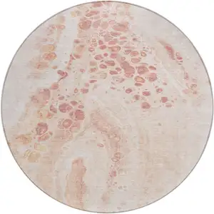 Photo of 8' Salmon And Ivory Round Abstract Washable Indoor Outdoor Area Rug