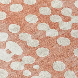 Photo of 8' Salmon And Ivory Round Abstract Washable Indoor Outdoor Area Rug