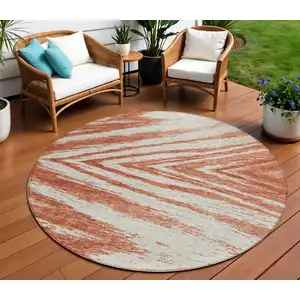 Photo of 8' Salmon And Ivory Round Abstract Washable Indoor Outdoor Area Rug
