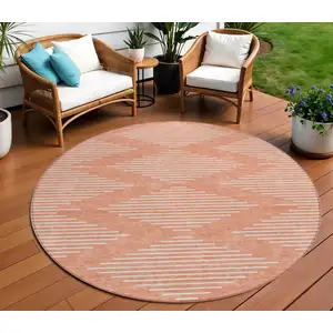 Photo of 8' Salmon And Ivory Round Geometric Washable Indoor Outdoor Area Rug