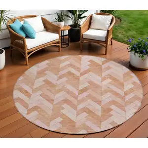 Photo of 8' Salmon And Ivory Round Geometric Washable Indoor Outdoor Area Rug