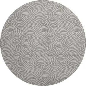 Photo of 8' Taupe And Ivory Abstract Washable Round Rug With UV Protection