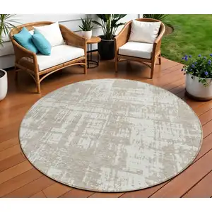 Photo of 8' Taupe And Ivory Round Abstract Washable Indoor Outdoor Area Rug