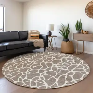 Photo of 8' Taupe And Ivory Round Geometric Washable Indoor Outdoor Area Rug