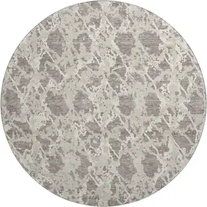 Photo of 8' Taupe Beige And Ivory Abstract Washable Round Rug With UV Protection