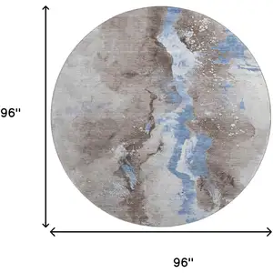 Photo of 8' Taupe Blue And Ivory Abstract Washable Round Rug With UV Protection