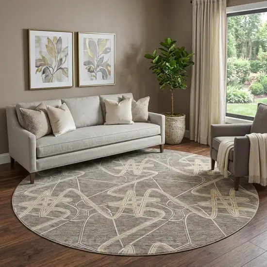 8' Taupe Gray And Gold Geometric Washable Round Rug With UV Protection Photo 1