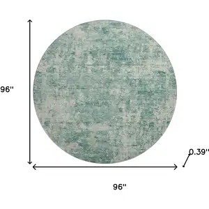 Photo of 8' Teal And Beige Abstract Washable Round Rug With UV Protection